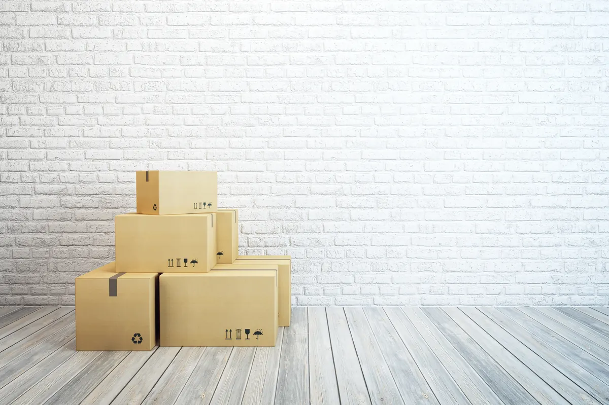Neatly packed and labelled moving boxes ready for removal during a deceased estate clearance
